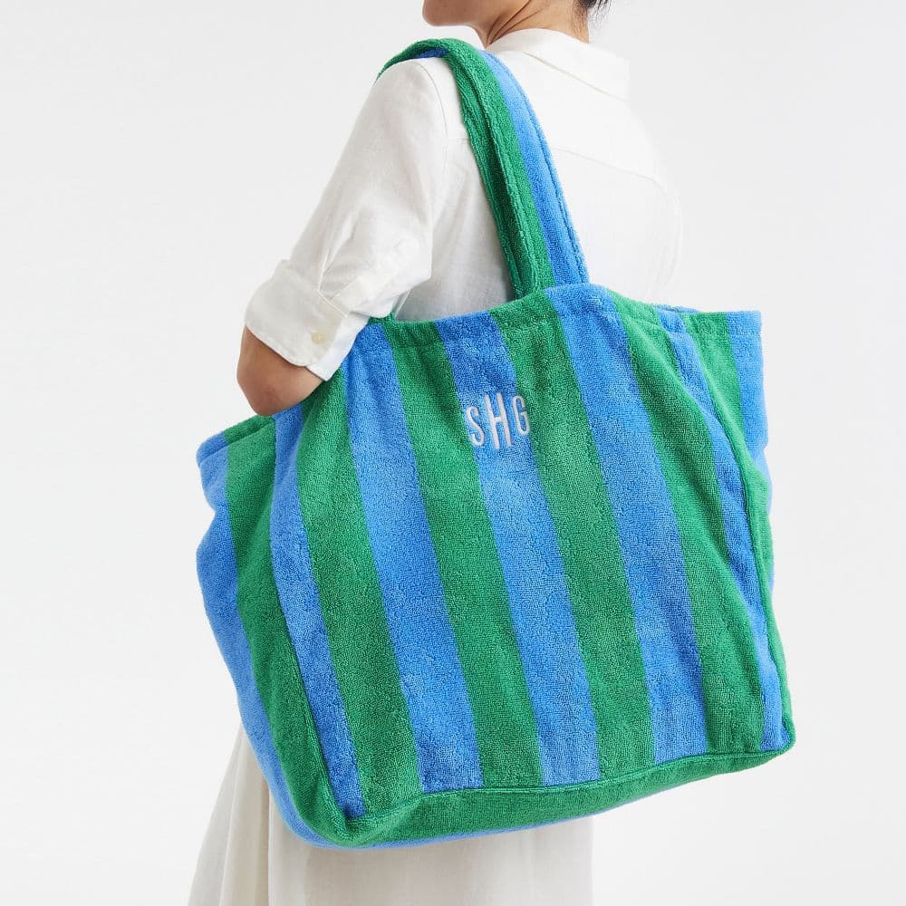 Large blue and green striped terry cloth tote bag with white monogrammed initials SHG.